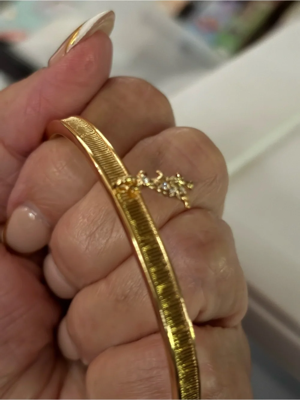 Coach Gold-Tone Textured Bangle with Star Crystal Accent Rexy